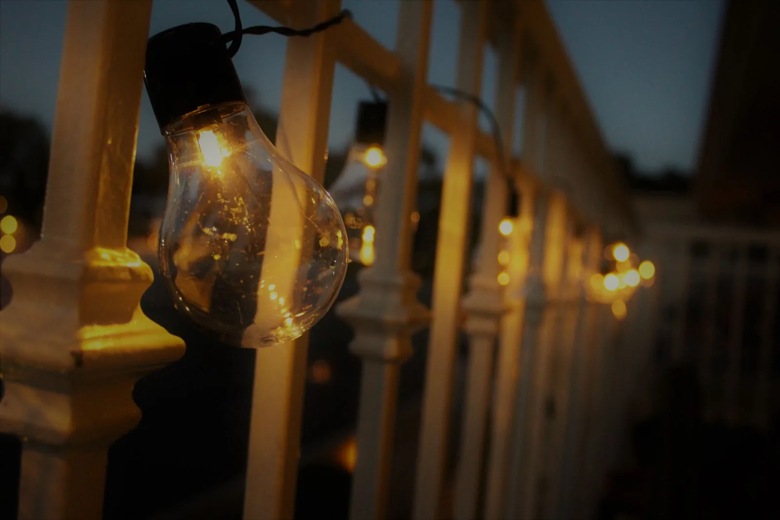 Best outdoor string lights hanging over a wooden pergola at dusk