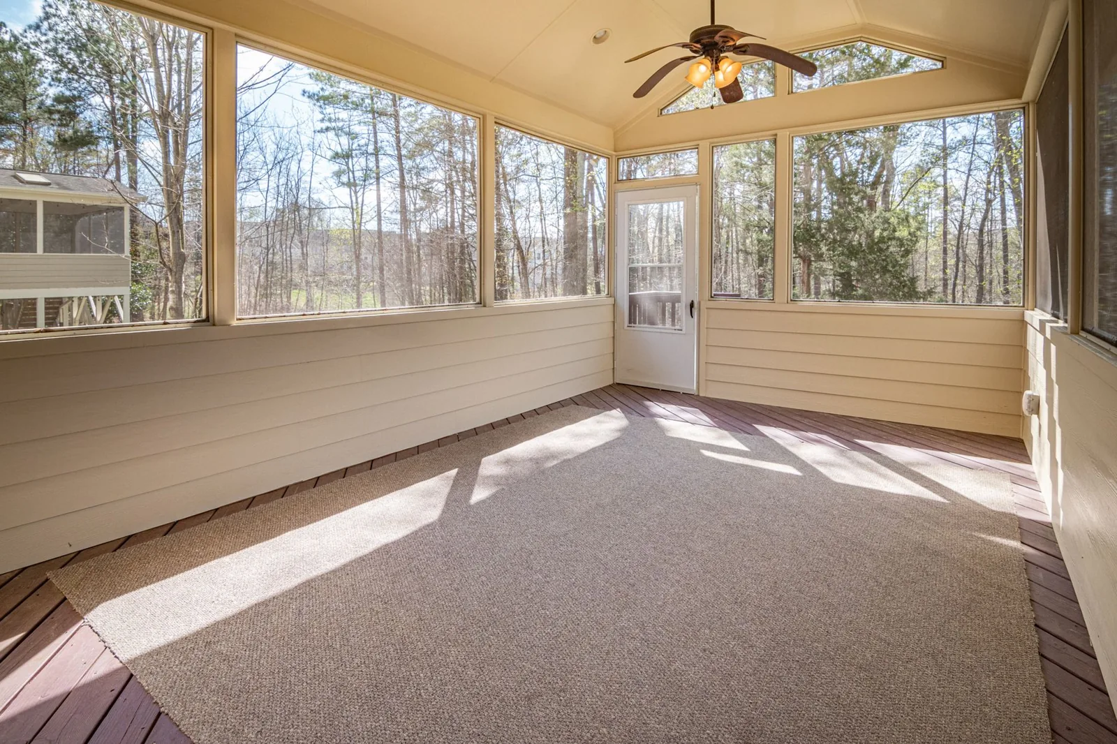 A four-season sunroom addition with large double-pane windows and an insulated roof