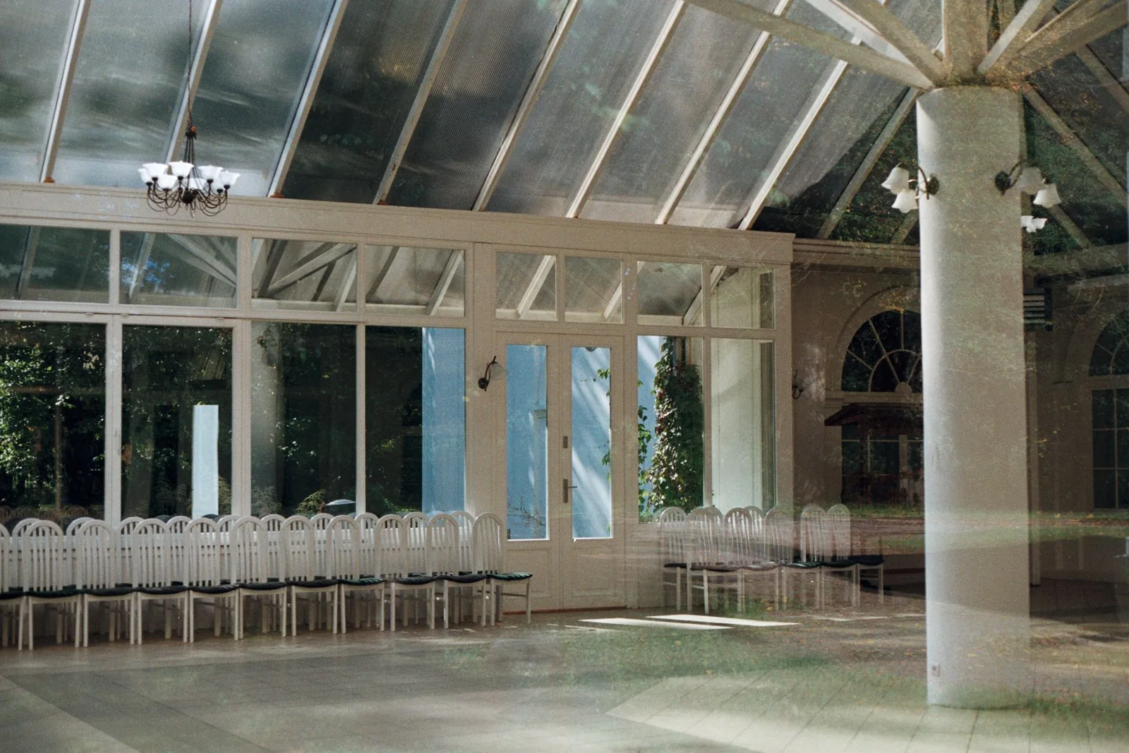 Light-filled four-season sunroom with glass ceiling panels