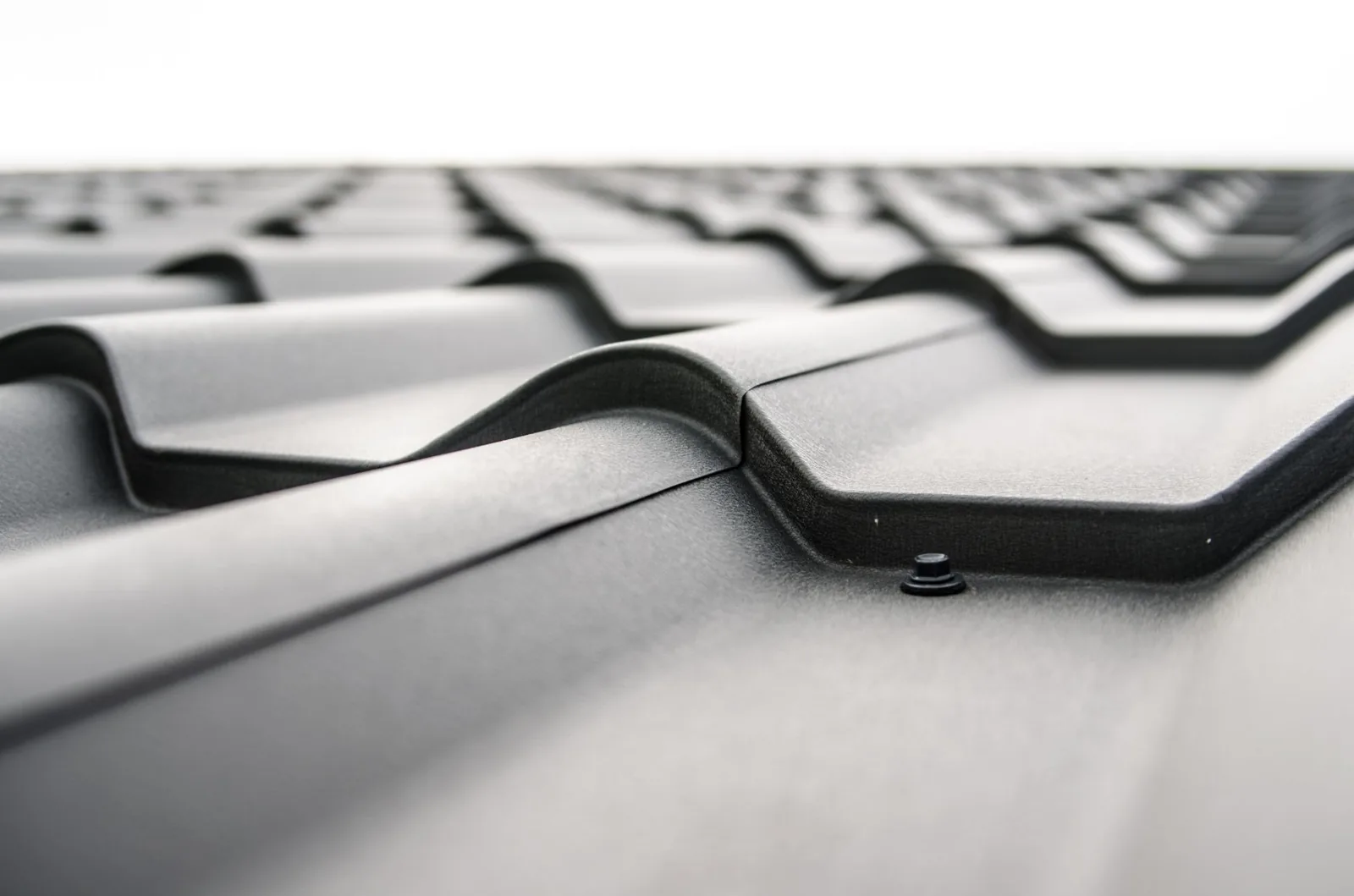 Close-up of a micro-mesh gutter guard blocking leaves and debris