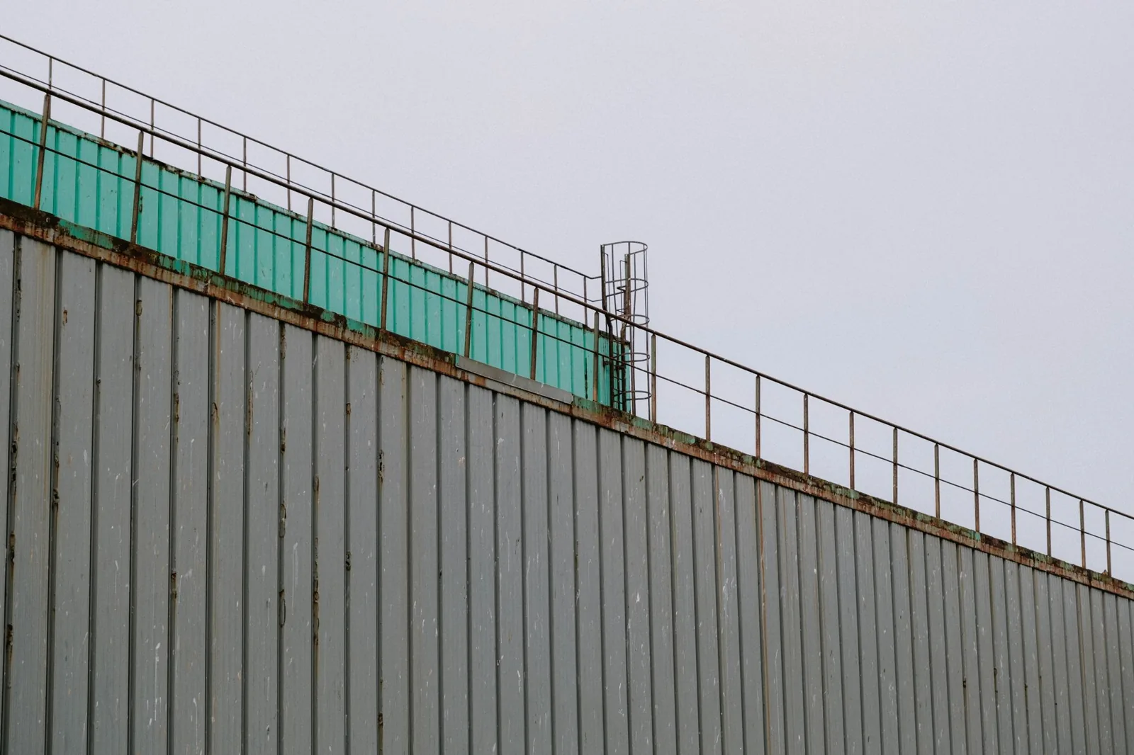 close-up of a gutter cover with debris sliding off the surface
