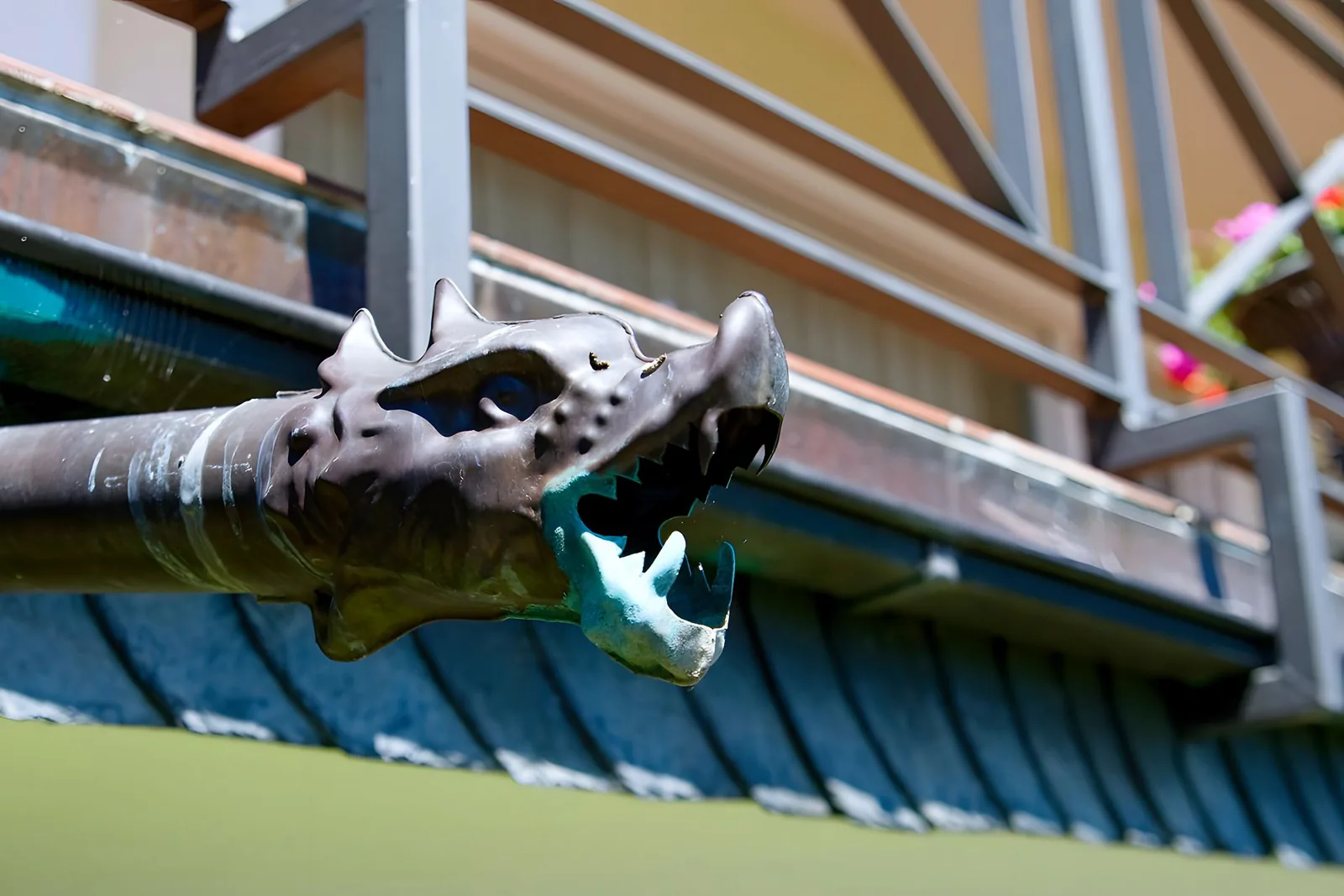 close-up of a half-round gutter with a round downspout on a traditional home