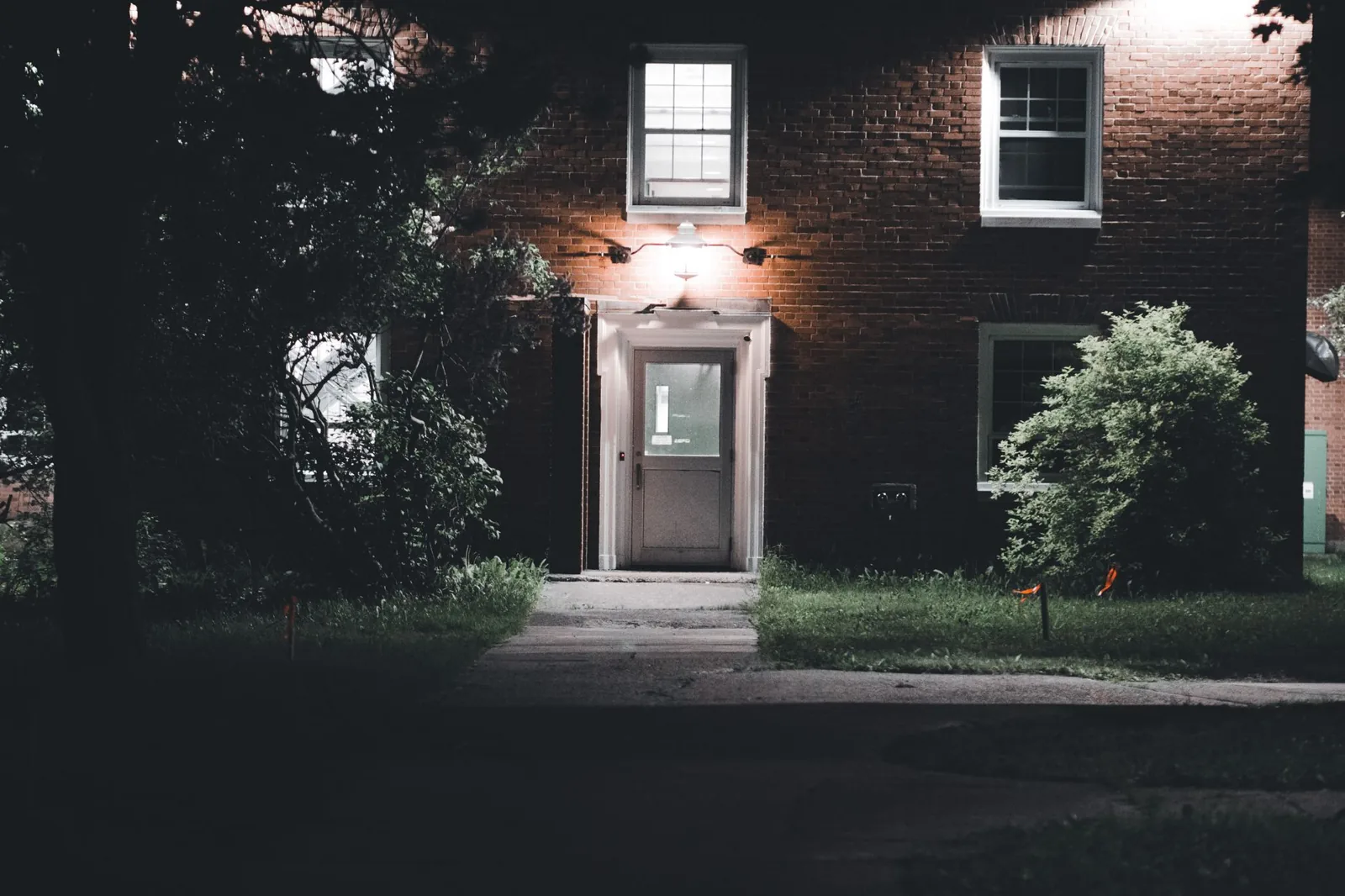 Warm uplighting on a front yard tree and facade
