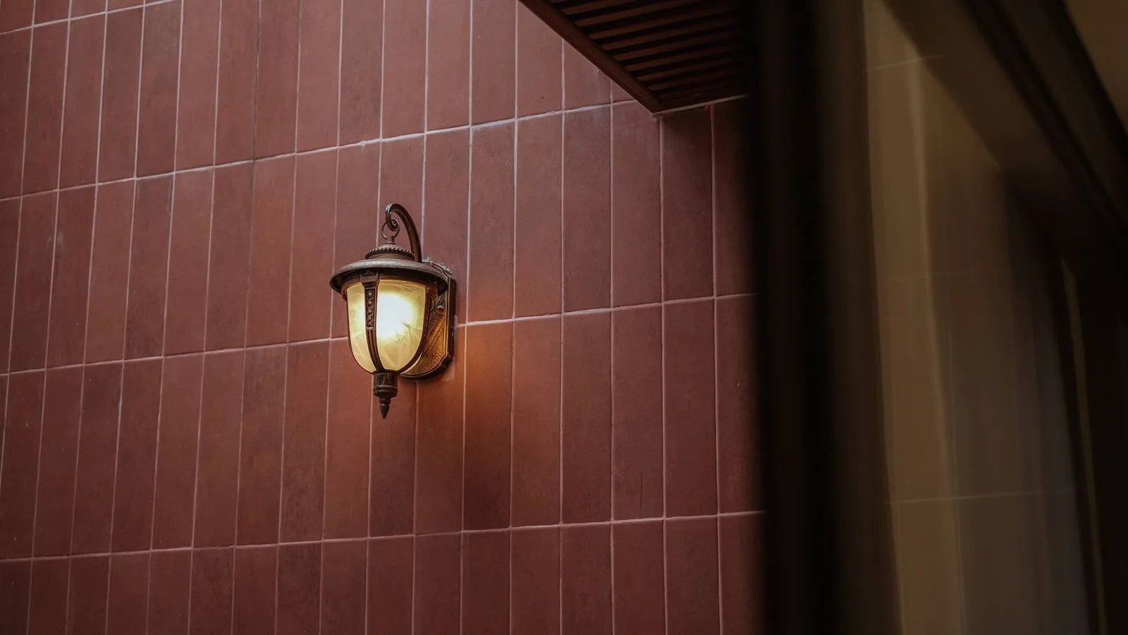 modern wall sconce on a brick exterior