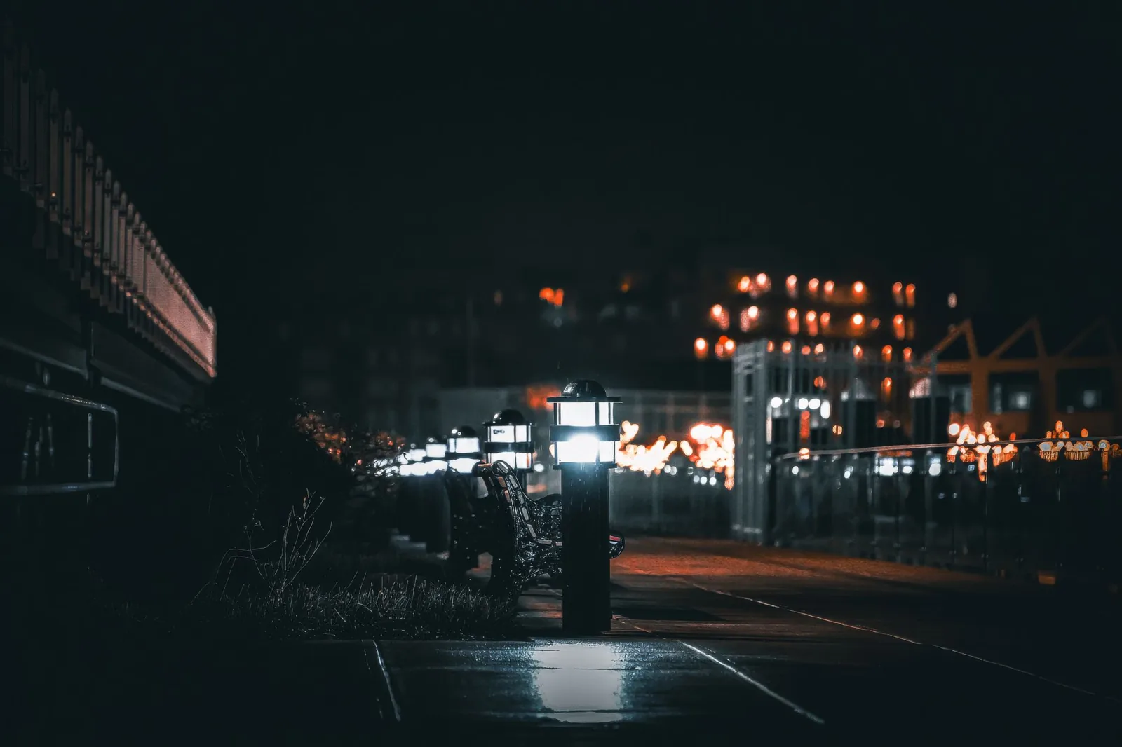 Low-voltage path lighting ideas illuminating a curved walkway at dusk