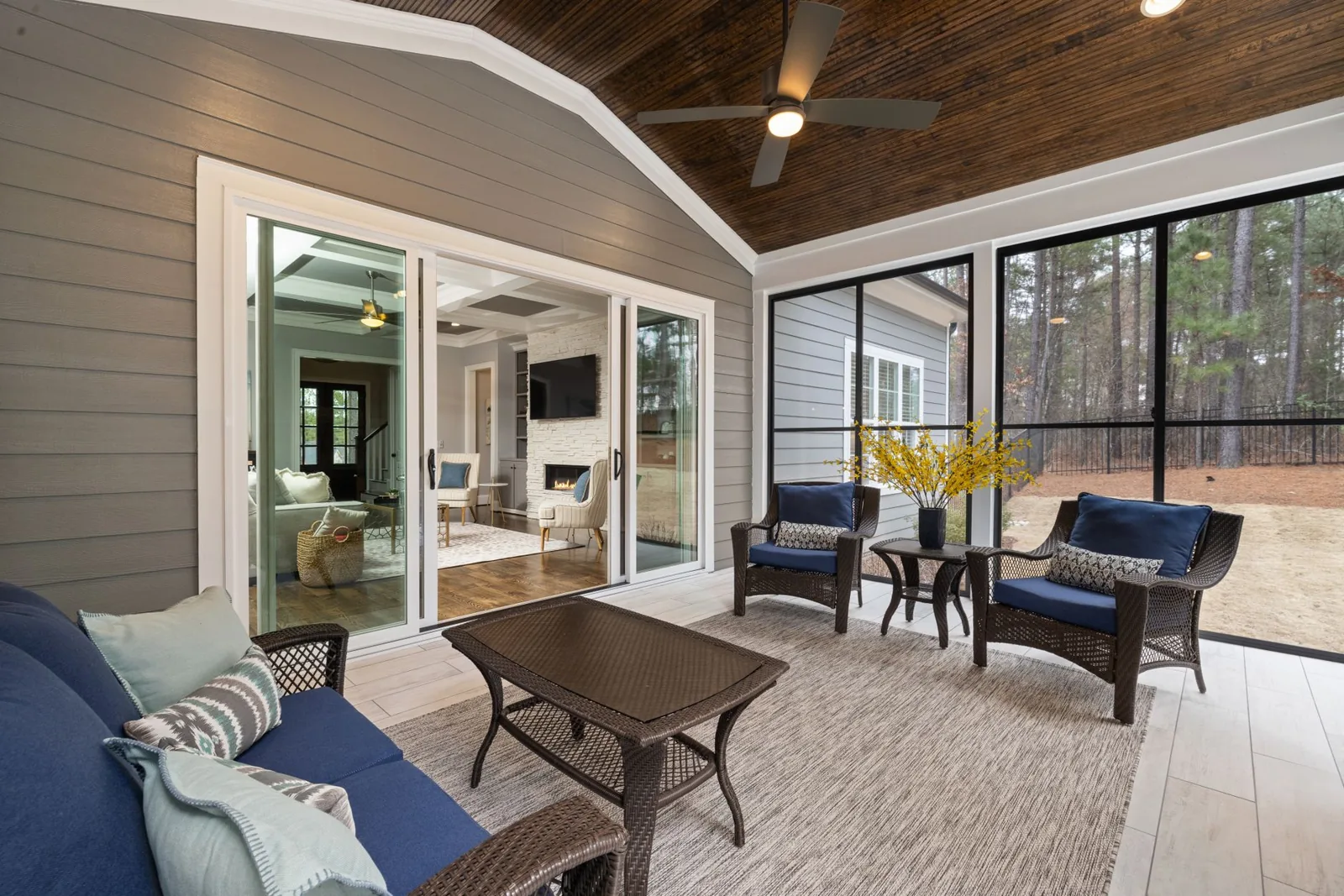 insulated sunroom addition with glass walls and a seating area
